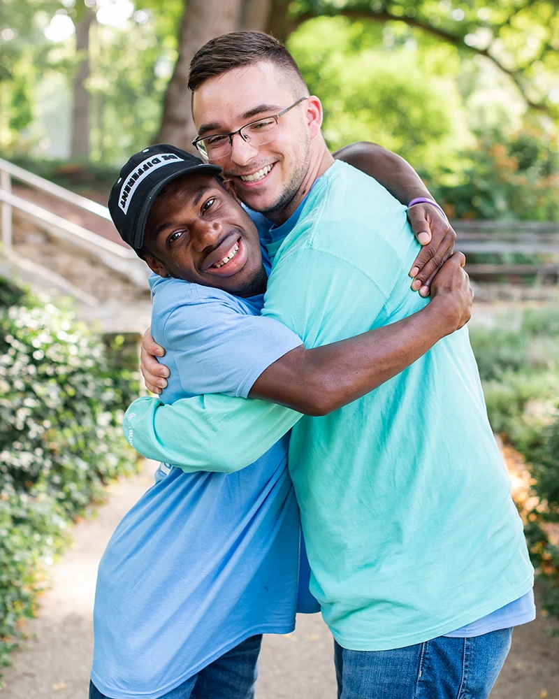 two best buddies participants hugging