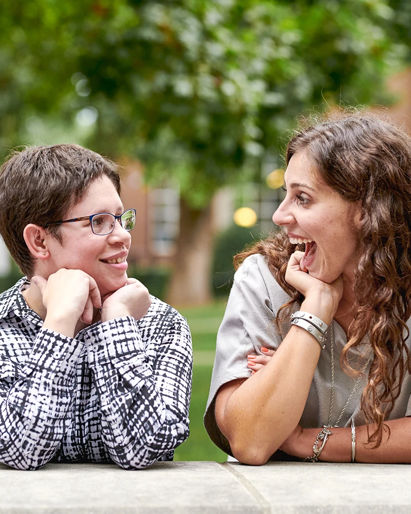 two participants smiling at one another