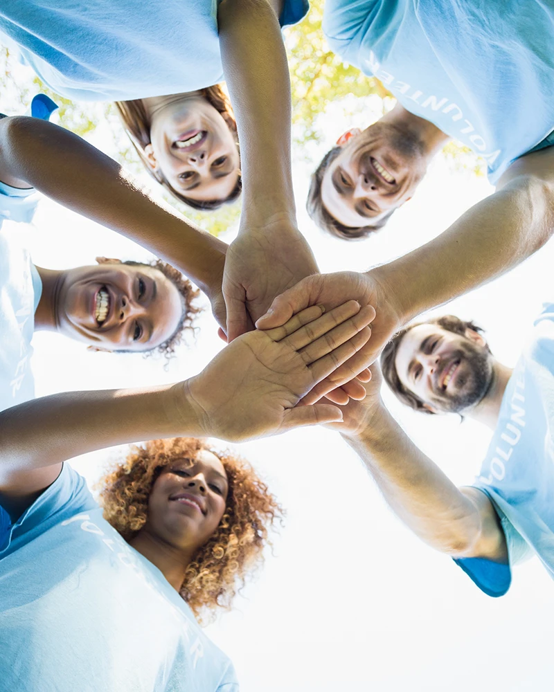 volunteers stacking hands